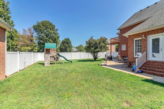 view of yard with a playground and a patio