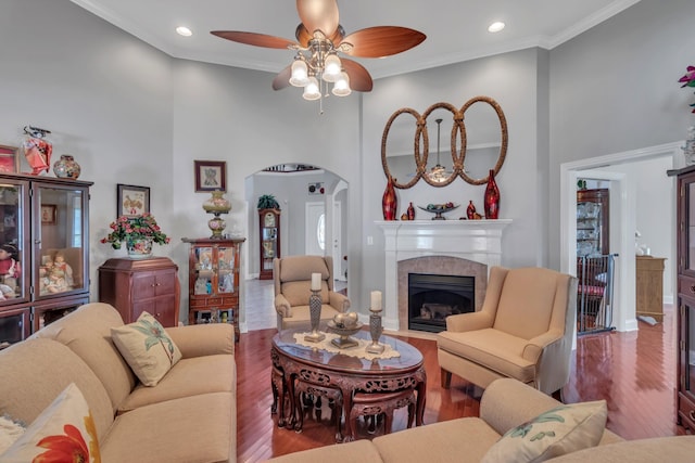 living room featuring hardwood / wood-style flooring, ornamental molding, and a fireplace