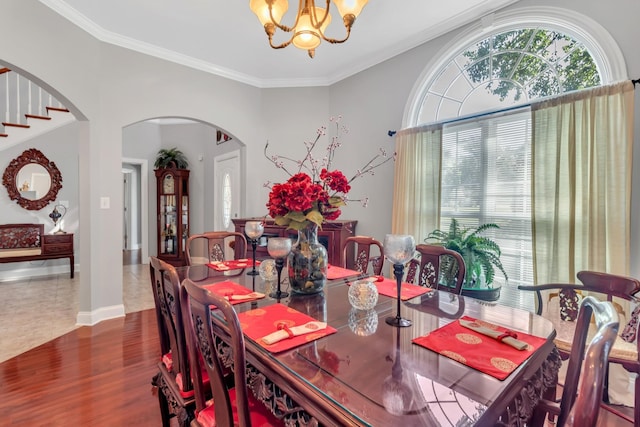 dining room featuring a notable chandelier, ornamental molding, and dark hardwood / wood-style floors