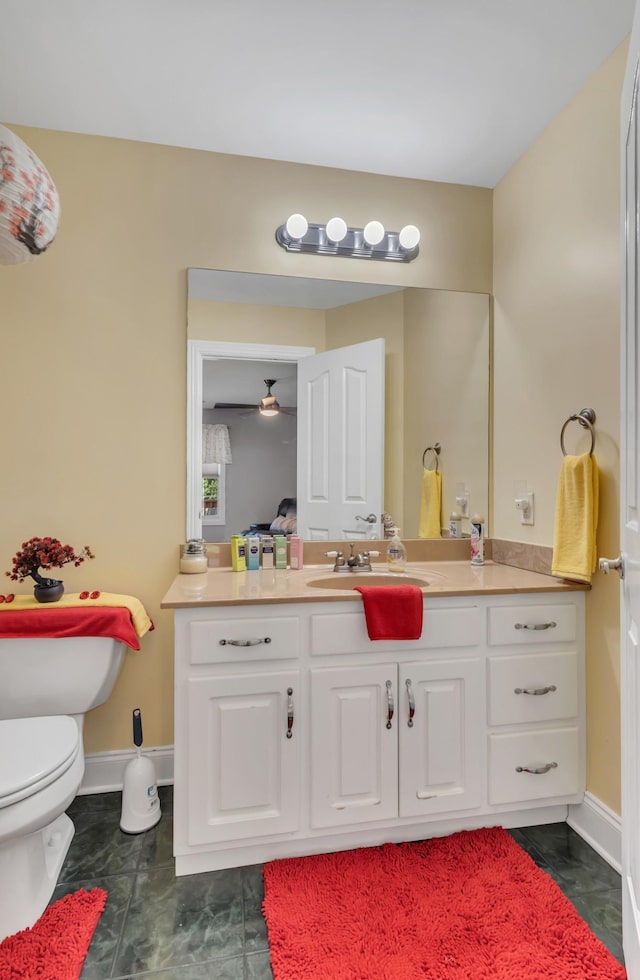 bathroom with tile patterned flooring, vanity, and toilet