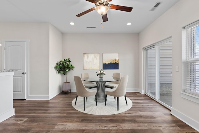 dining area with dark wood-type flooring and ceiling fan