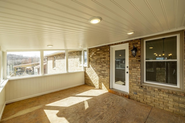 unfurnished sunroom featuring wooden ceiling