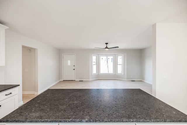 foyer entrance with ceiling fan