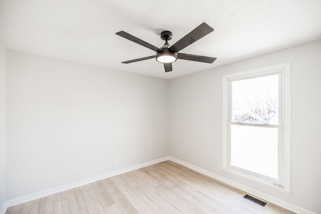 unfurnished room featuring a textured ceiling, ceiling fan, and light wood-type flooring