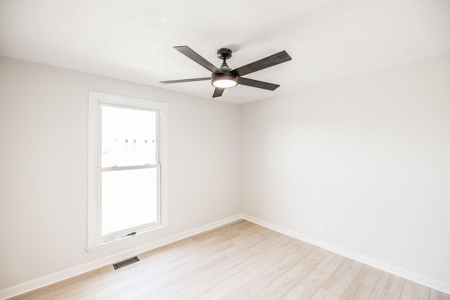 unfurnished room with a textured ceiling, ceiling fan, and light wood-type flooring