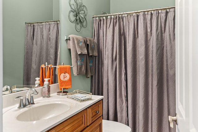 bathroom featuring vanity and toilet