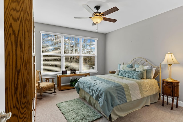 bedroom featuring ceiling fan and light carpet