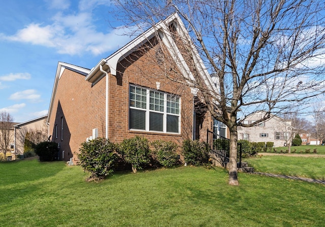 view of side of home with a yard