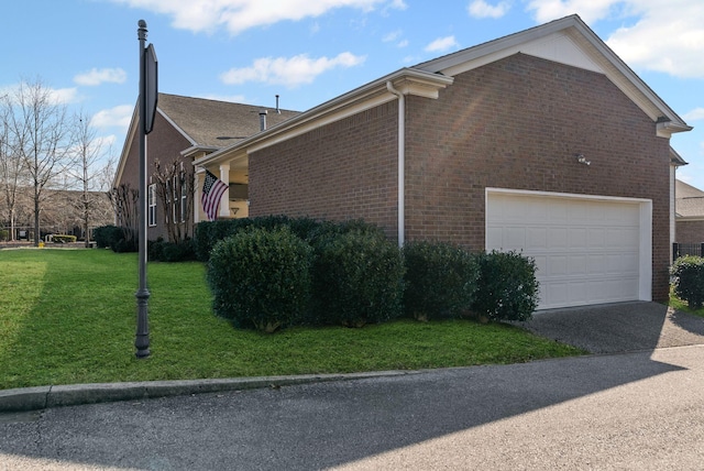 view of property exterior with a garage and a lawn