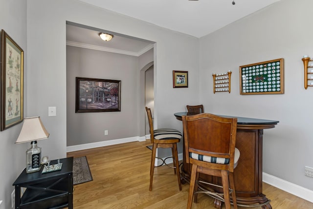 interior space with hardwood / wood-style flooring and ornamental molding