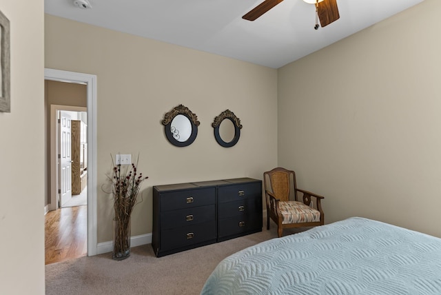 bedroom with ceiling fan and light carpet