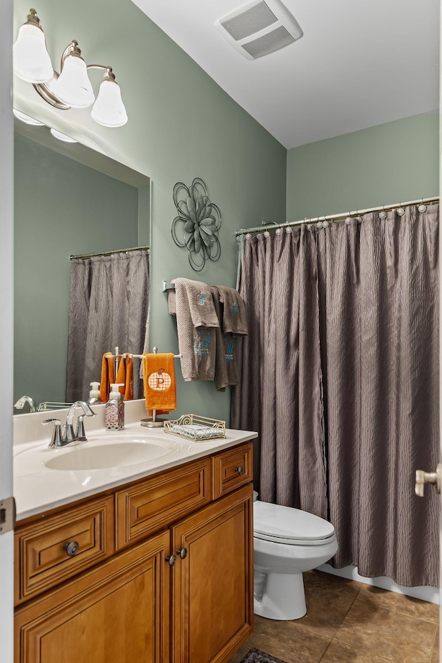 bathroom with vanity, tile patterned floors, and toilet