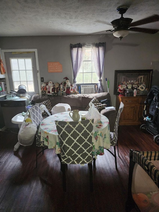 dining space with cooling unit, ceiling fan, hardwood / wood-style flooring, and a textured ceiling