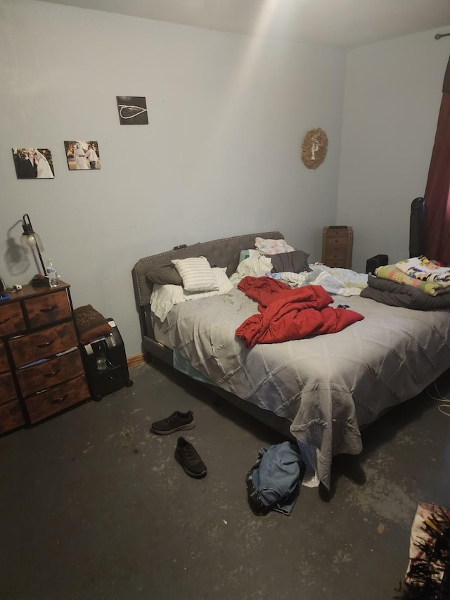 bedroom featuring concrete floors