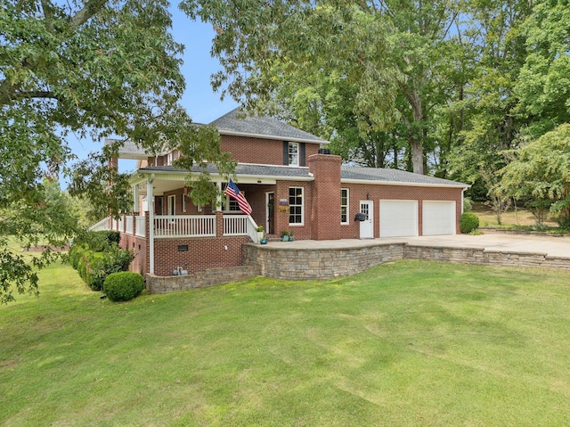 view of front of property featuring a garage, a front lawn, and covered porch