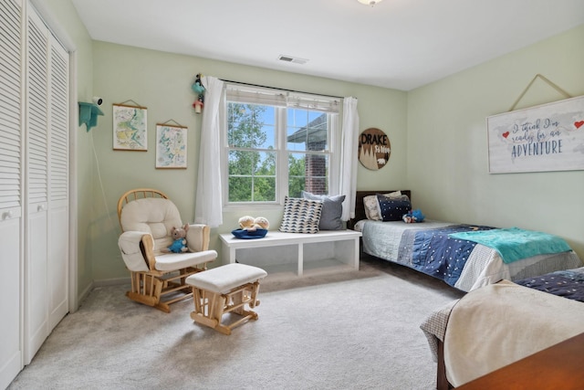 bedroom with light colored carpet and a closet