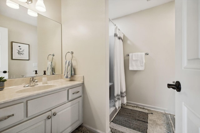 bathroom featuring vanity and curtained shower