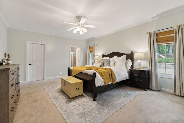 bedroom with ensuite bathroom, crown molding, light carpet, and ceiling fan