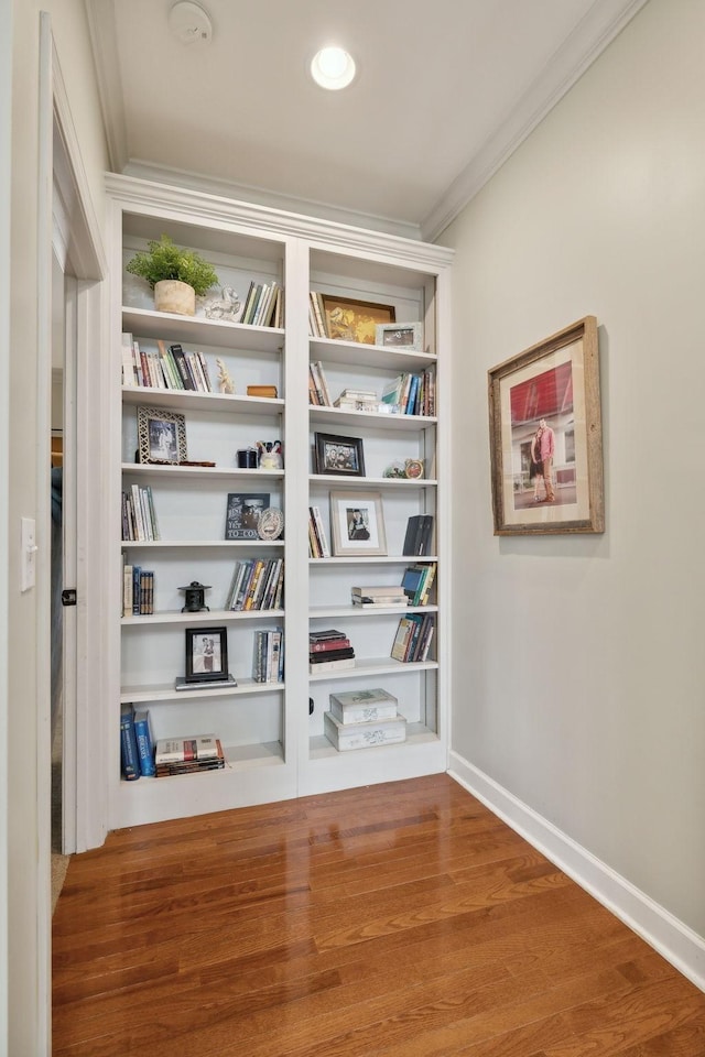 interior details with hardwood / wood-style floors and crown molding