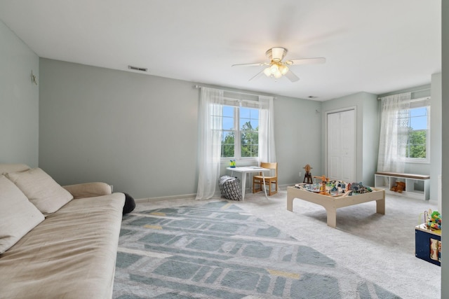 carpeted living room featuring ceiling fan