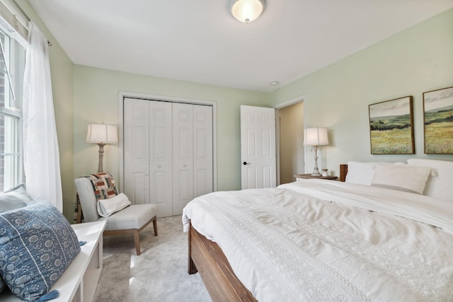 carpeted bedroom featuring multiple windows and a closet