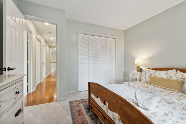 bedroom with light colored carpet and a closet