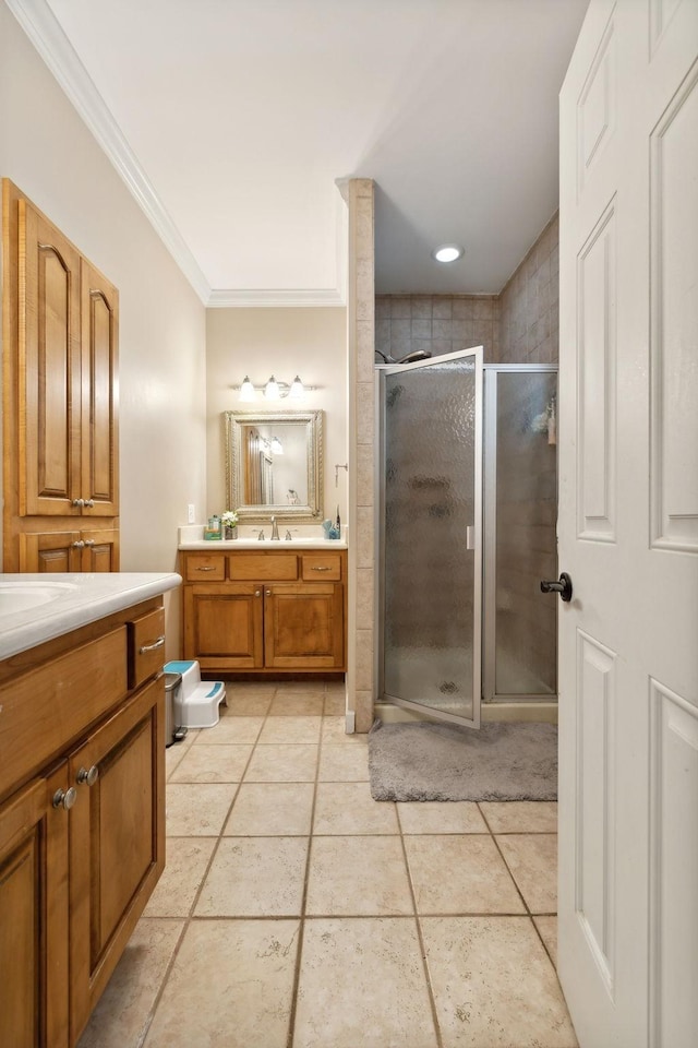 bathroom featuring crown molding, an enclosed shower, tile patterned floors, and vanity