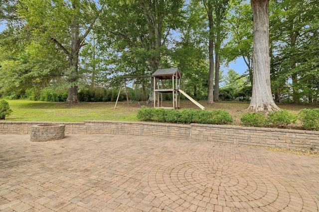 view of jungle gym featuring a patio area