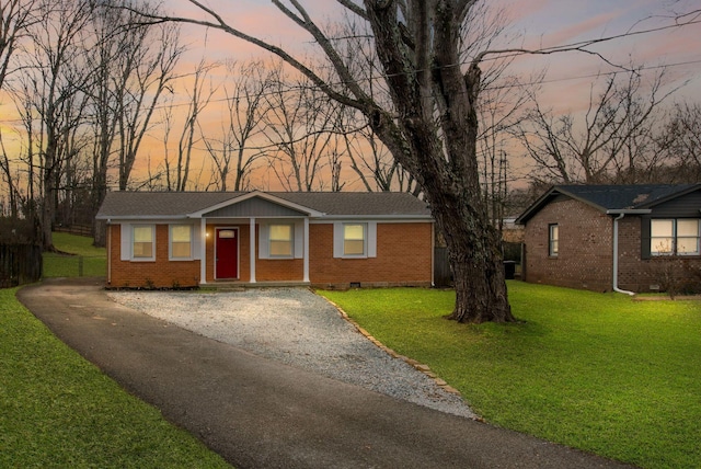 ranch-style house featuring a yard