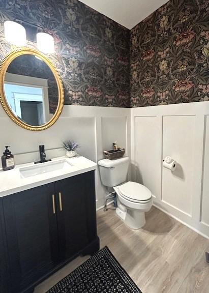 bathroom featuring hardwood / wood-style flooring, vanity, and toilet