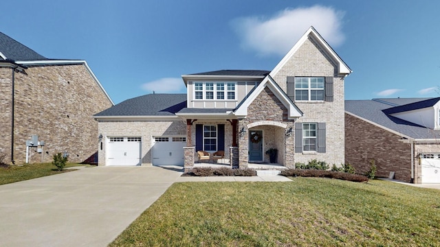 view of front of property featuring a garage, a front yard, and covered porch