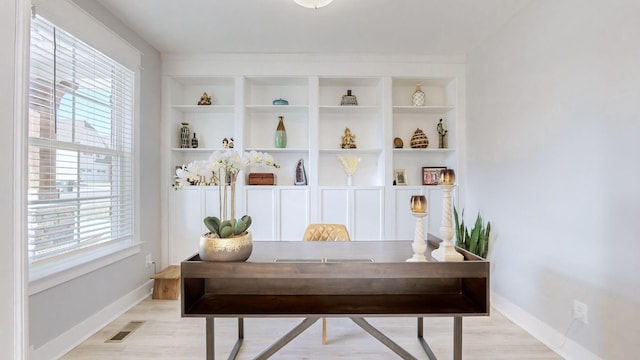 interior space with built in shelves and a wealth of natural light