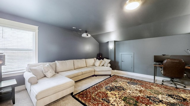 living room with a healthy amount of sunlight, vaulted ceiling, and light carpet