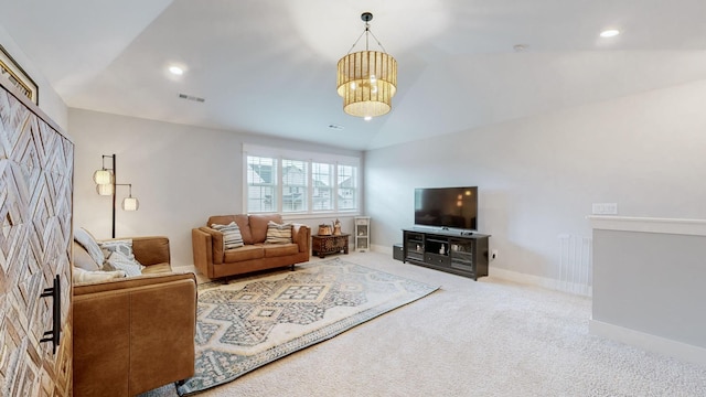 carpeted living room with vaulted ceiling and a notable chandelier