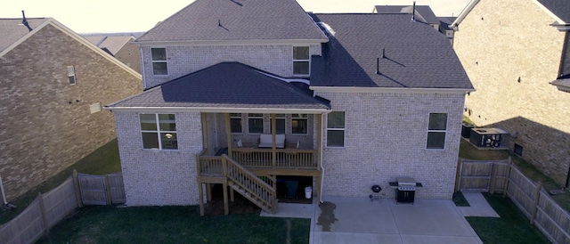 back house at dusk featuring a patio area