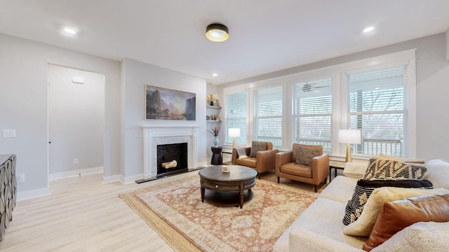 living room featuring built in features and light wood-type flooring