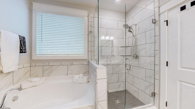 bathroom with shower with separate bathtub