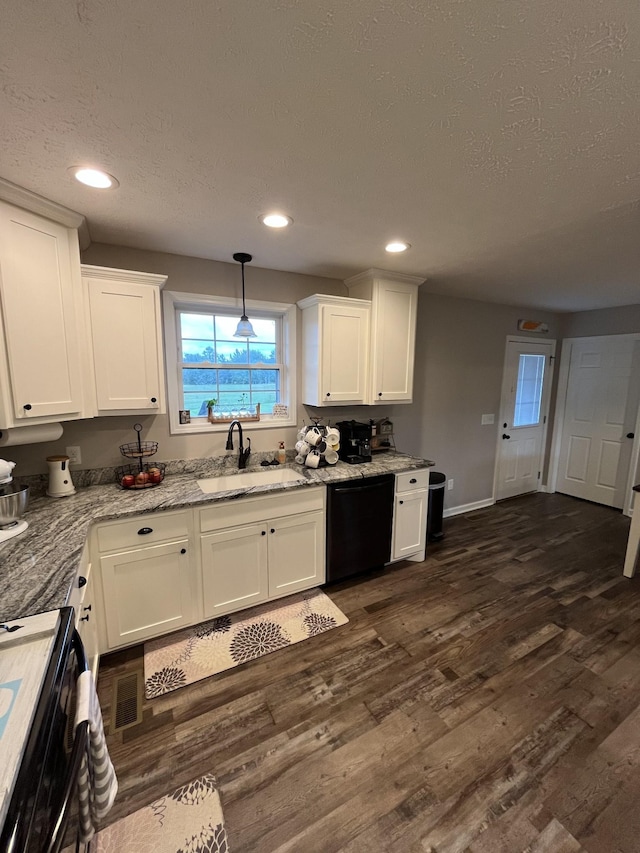 kitchen with sink, hanging light fixtures, black appliances, white cabinets, and dark hardwood / wood-style flooring