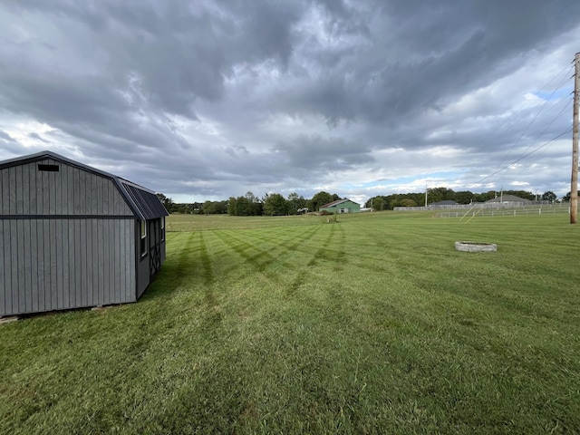 view of yard with an outbuilding and a rural view