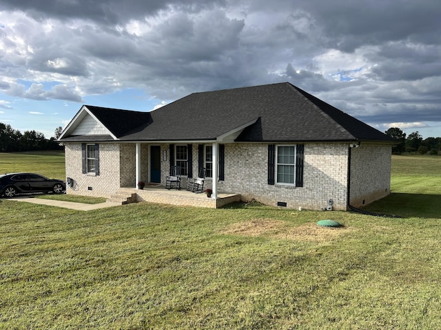 ranch-style house featuring a front yard, covered porch, and a patio area