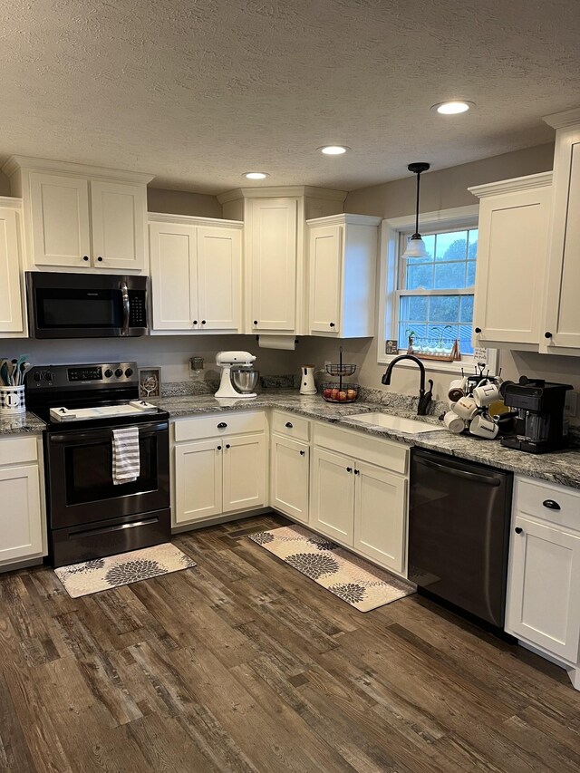 kitchen featuring sink, white cabinets, a textured ceiling, and black appliances