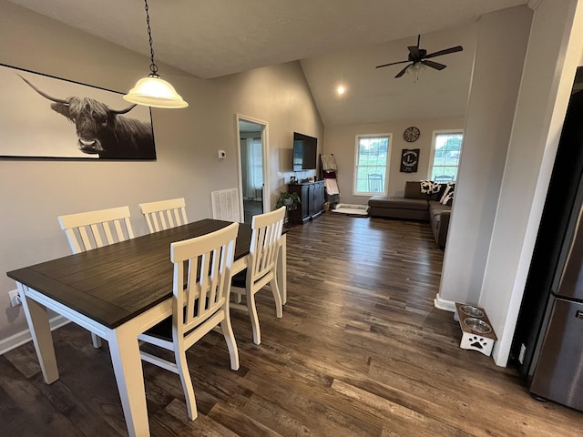 dining room featuring dark wood-type flooring, ceiling fan, and vaulted ceiling