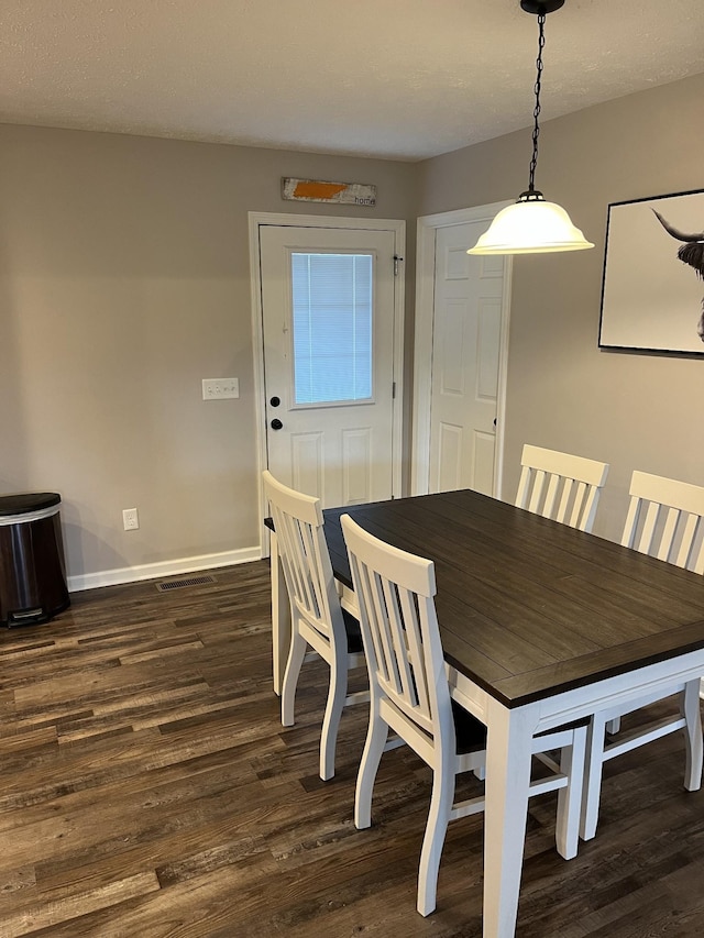 dining space featuring dark hardwood / wood-style floors