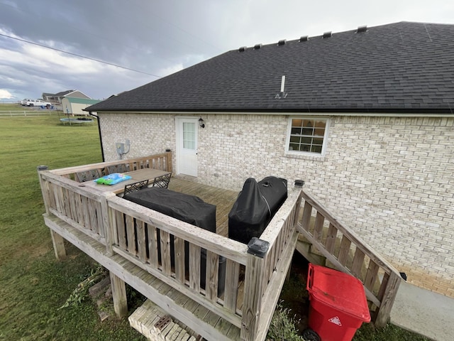 deck featuring area for grilling and a lawn