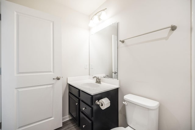 bathroom with vanity, wood-type flooring, and toilet