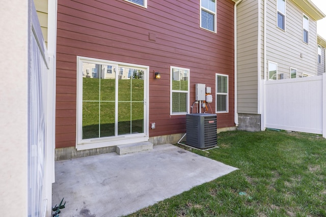 exterior space with a yard, a patio, and central air condition unit