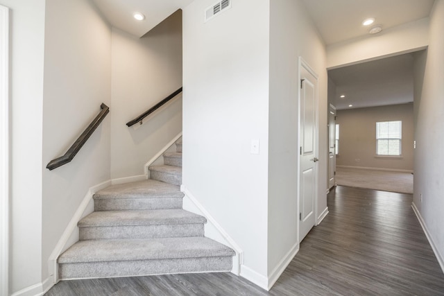 stairway featuring hardwood / wood-style flooring