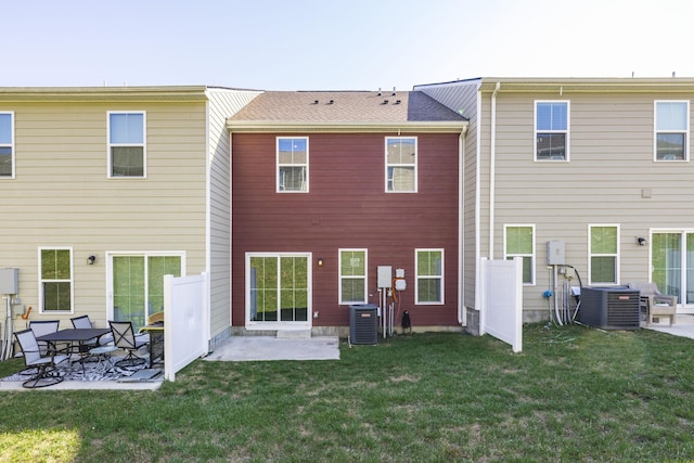 rear view of property with central AC unit, a yard, and a patio