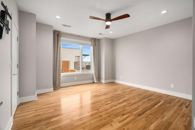 spare room with ceiling fan and light hardwood / wood-style flooring