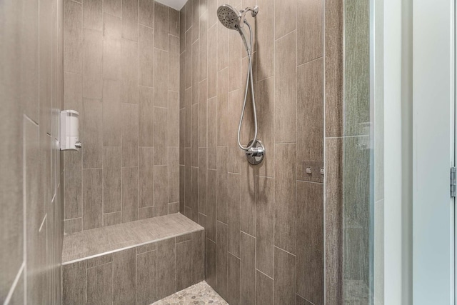 bathroom with tiled shower